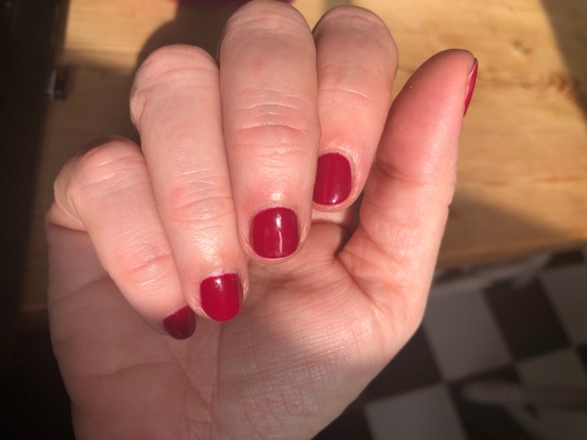 Hand with very red nails